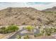 Scenic aerial view of desert landscape with winding road, lush green trees, and distant homes at 3545 N Vista Way # 404, Buckeye, AZ 85396
