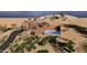 Expansive aerial view of a modern desert estate, highlighting its unique architectural design and pool at 3545 N Vista Way # 404, Buckeye, AZ 85396
