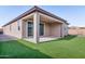 The backyard offers a covered patio area, artificial grass and desert landscaping for easy maintenance, relaxation, and entertainment at 3623 S 78Th Dr, Phoenix, AZ 85043