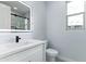 Stylish bathroom with a single vanity, quartz countertops, illuminated mirror, and a separate water closet for added privacy at 3623 S 78Th Dr, Phoenix, AZ 85043