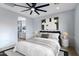 Digitally staged bedroom showcases a comfortable bed, stylish decor, and access to an en-suite bathroom for added privacy at 3623 S 78Th Dr, Phoenix, AZ 85043