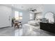 Stylishly staged bedroom with a ceiling fan, neutral decor, and ample natural light through large windows at 3623 S 78Th Dr, Phoenix, AZ 85043