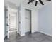 This bedroom boasts neutral paint, ceramic floors, and an open closet providing ample space for storage and organization at 3623 S 78Th Dr, Phoenix, AZ 85043