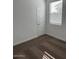 A bedroom with a window, carpet flooring, and a white door at 38150 W Bello Ln, Maricopa, AZ 85138