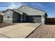 Gray one-story home with desert landscaping and an attached two-car garage with a concrete driveway at 38150 W Bello Ln, Maricopa, AZ 85138