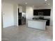 Modern kitchen with granite countertops, stainless steel appliances, and a center island at 38150 W Bello Ln, Maricopa, AZ 85138