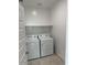 Laundry room with white washer and dryer at 38150 W Bello Ln, Maricopa, AZ 85138