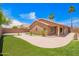 Backyard featuring artificial turf, a tiled patio, and a landscaped yard at 3913 E Derringer Way, Gilbert, AZ 85297