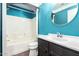 Bathroom boasts blue walls, a round mirror, and a shower over the tub at 3913 E Derringer Way, Gilbert, AZ 85297