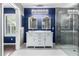 Luxurious bathroom with a double vanity, chandelier, and walk-in shower at 3913 E Derringer Way, Gilbert, AZ 85297