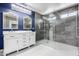 Upgraded bathroom with double vanity, walk-in shower, and modern lighting fixtures at 3913 E Derringer Way, Gilbert, AZ 85297