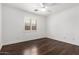 Bright bedroom with hardwood floors, ceiling fan and window shutters at 3913 E Derringer Way, Gilbert, AZ 85297