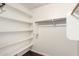 Organized walk-in closet with custom shelving and wood floors at 3913 E Derringer Way, Gilbert, AZ 85297