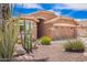 Southwest home featuring desert landscaping, including cacti, rocks, and flowering bushes at 3913 E Derringer Way, Gilbert, AZ 85297