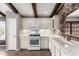 Eat-in kitchen showcases white cabinets, white appliances, and a stone accent wall at 3913 E Derringer Way, Gilbert, AZ 85297
