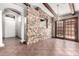 Living area with tile floors, stone wall separating the entry, wood beams, and a chandelier at 3913 E Derringer Way, Gilbert, AZ 85297