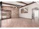 Living room boasts tile floors, backyard access via glass doors, and a stone accent wall at 3913 E Derringer Way, Gilbert, AZ 85297