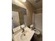Bright bathroom with a white sink, neutral cabinets, and a shower-tub combination, offering a clean and functional space at 40246 W Hopper Dr, Maricopa, AZ 85138