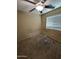 A clean bedroom featuring neutral walls, carpet flooring, a ceiling fan, and natural light at 40246 W Hopper Dr, Maricopa, AZ 85138