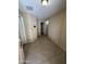 Hallway featuring tile floors, leading to an open door that reveals the rest of the property at 40246 W Hopper Dr, Maricopa, AZ 85138