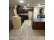 Spacious kitchen featuring dark cabinetry, tile flooring and an island for extra counter space at 40246 W Hopper Dr, Maricopa, AZ 85138