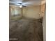 Empty living room with carpet flooring, fan and a stairway leading to the second floor at 40246 W Hopper Dr, Maricopa, AZ 85138