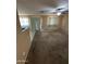 Spacious room with carpet flooring and neutral walls with a sliding glass door to the outside at 40246 W Hopper Dr, Maricopa, AZ 85138