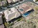 An aerial view of a luxury home with a pool and an outdoor seating area. Solar panels are also visible at 42023 N Bridlewood Way, Anthem, AZ 85086