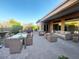 Expansive backyard patio furnished with comfortable seating and dining areas, complemented by lush greenery and scenic views at 42023 N Bridlewood Way, Anthem, AZ 85086
