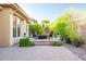 An outdoor firepit surrounded by chairs, mature landscaping, and pavers enhance the outdoor backyard living space at 42023 N Bridlewood Way, Anthem, AZ 85086