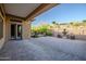 Paver patio with a view of a fountain, and a grassy slope leading up to neighboring properties at 42023 N Bridlewood Way, Anthem, AZ 85086