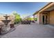 Backyard features a paver patio, an outdoor dining space, a decorative fountain, and well-manicured landscaping at 42023 N Bridlewood Way, Anthem, AZ 85086