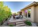 Backyard with a patio featuring a fire pit, seating, lush greenery, and desert landscape at 42023 N Bridlewood Way, Anthem, AZ 85086