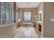 Serene bathroom with a luxurious soaking tub, elegant chandelier and ample counter space for relaxation at 42023 N Bridlewood Way, Anthem, AZ 85086