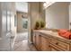 Bathroom featuring a single sink, wood cabinetry, decorative countertop, and an open view to a bedroom at 42023 N Bridlewood Way, Anthem, AZ 85086