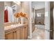 Nicely-lit bathroom with a single sink vanity featuring a tiled countertop and a full shower-tub combo at 42023 N Bridlewood Way, Anthem, AZ 85086