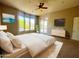 Spacious bedroom with neutral carpet, an accent wall and large windows that fill the space with natural light at 42023 N Bridlewood Way, Anthem, AZ 85086