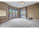 Bright bedroom features plush carpet and large windows overlooking the meticulously manicured backyard at 42023 N Bridlewood Way, Anthem, AZ 85086