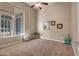 Large bedroom with ample natural light, plush carpeting, and decoratively-framed artwork at 42023 N Bridlewood Way, Anthem, AZ 85086