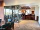 Elegant dining area with glass-enclosed wine cellar and bar, perfect for entertaining guests at 42023 N Bridlewood Way, Anthem, AZ 85086