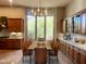 Elegant dining room featuring a wood table with seating for eight, surrounded by cabinetry, and large windows at 42023 N Bridlewood Way, Anthem, AZ 85086
