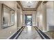 Inviting foyer featuring tile flooring with decorative accents, a modern light fixture, and neutral paint at 42023 N Bridlewood Way, Anthem, AZ 85086