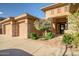 Beautiful home exterior with a well-manicured front yard, desert landscaping, and a three-car garage at 42023 N Bridlewood Way, Anthem, AZ 85086