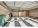 Spacious garage with black and white tile, ample storage shelves, and room for multiple vehicles or hobbies at 42023 N Bridlewood Way, Anthem, AZ 85086