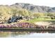 Golf course with a decorative waterfall, vibrant flower beds, and a scenic mountain backdrop at 42023 N Bridlewood Way, Anthem, AZ 85086