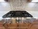 Close-up of a stainless steel gas cooktop with sleek knobs and a stylish backsplash, set in a modern kitchen at 42023 N Bridlewood Way, Anthem, AZ 85086