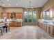 Open kitchen design with wooden cabinets, island, stainless steel appliances, and large windows for plenty of natural light at 42023 N Bridlewood Way, Anthem, AZ 85086