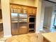Kitchen with stainless steel appliances, built-in oven, and custom wood cabinetry at 42023 N Bridlewood Way, Anthem, AZ 85086