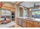 Kitchen with stainless steel appliances, built-in oven, and custom wood cabinetry at 42023 N Bridlewood Way, Anthem, AZ 85086
