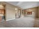 Spacious living room featuring neutral tones, chandelier, and seamless flow into adjacent areas at 42023 N Bridlewood Way, Anthem, AZ 85086